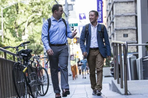 Two students walking on campus