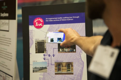Person holds phone up to an interactive map