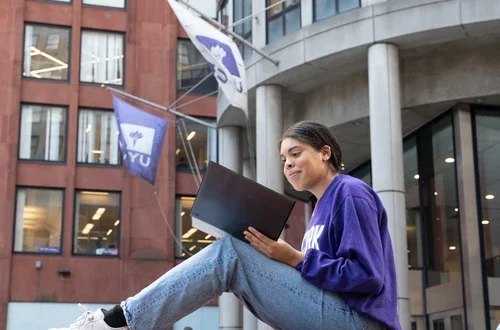 A student poses on Gould Plaza