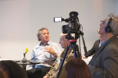 Harry Chernoff speaking and being recorded by a camera