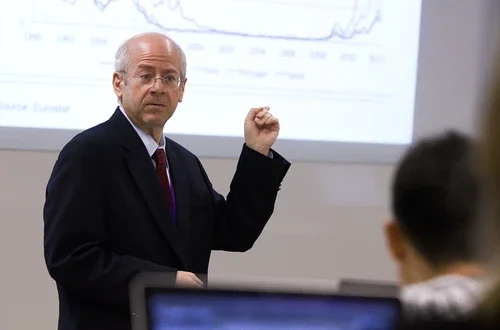 Kim Schoenholtz points at a projection of a graph