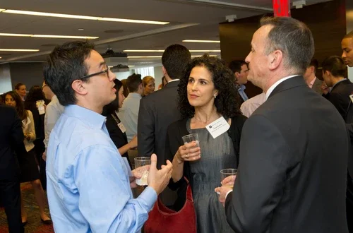 Three people with drinks, talking
