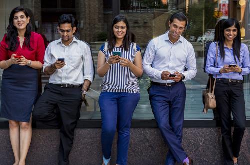 Students on their phones in Gould Plaza