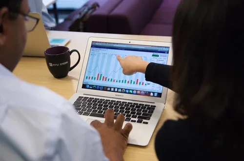 Students pointing at laptop screen