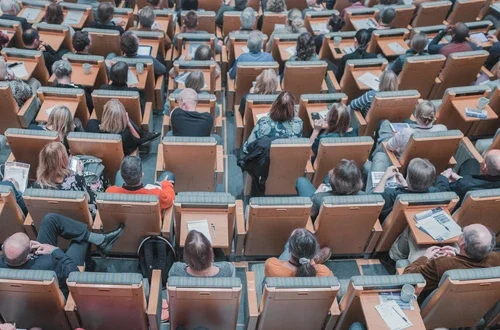 Seated adults in a lecture hall