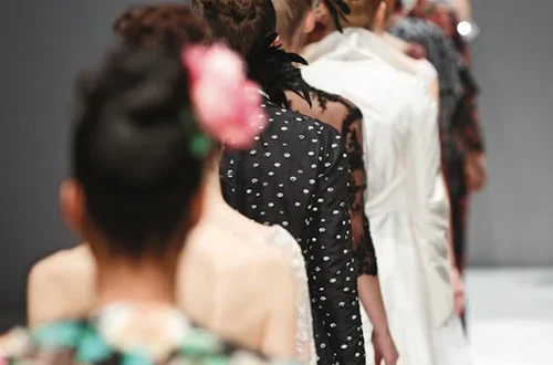 Women in single-file line on a fashion show runway