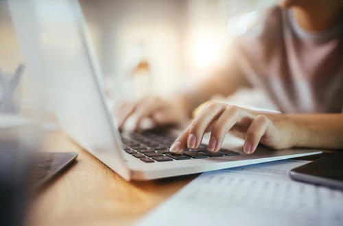 Girl typing on a laptop 