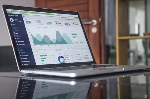 A laptop screen showing graphs and numbers