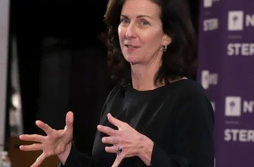 kathleen derose in a black blouse speaking to an audience