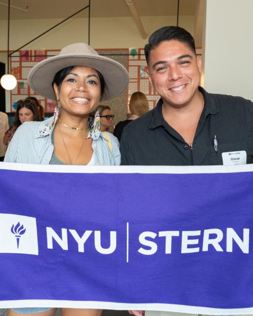 Recent alumni pose at a Stern 10 event