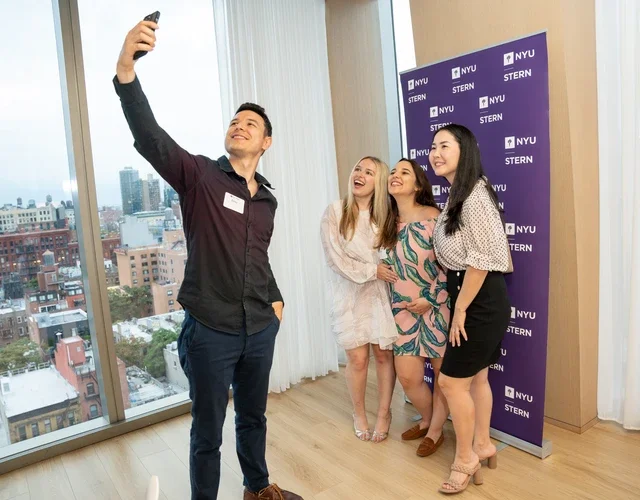 Stern alumni pose for a selfie