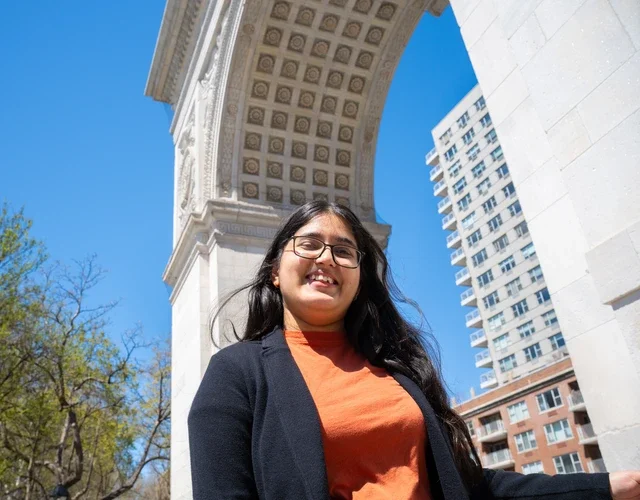 Student under Washington Square Arch