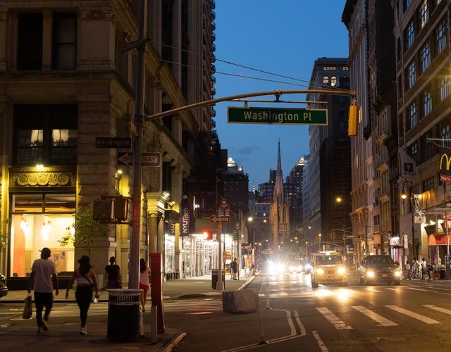 Washington Place at Broadway at night looking north on Broadway towards Grace Church