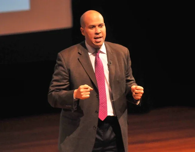 Man in a suit speaking on a stage