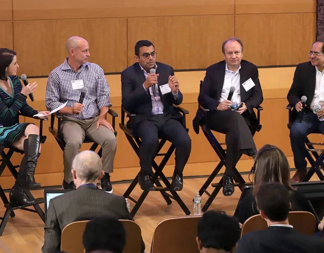 Panelists speaking at the FinTech conference