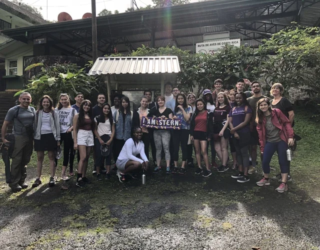 Group of students standing with an "I Am Stern" sign 