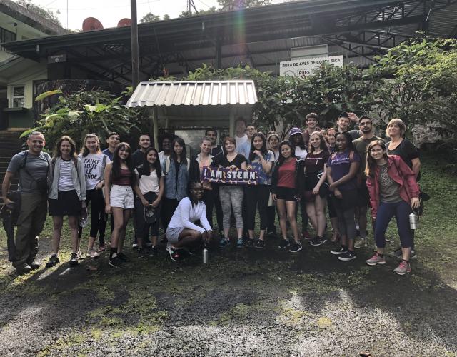 Group of students standing with an "I Am Stern" sign 