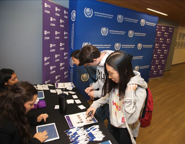 Students checking in at a table for an event