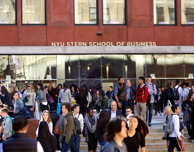 NYU Stern students gather in front of Tisch Hall on a sunny day in New York City
