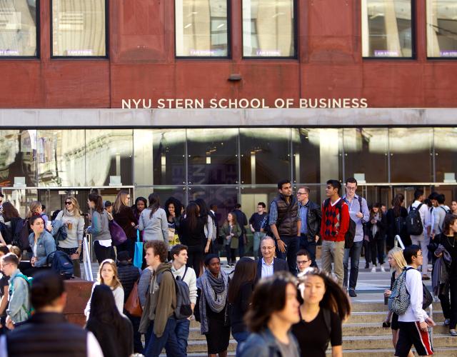 NYU Stern students gather in front of Tisch Hall on a sunny day in New York City