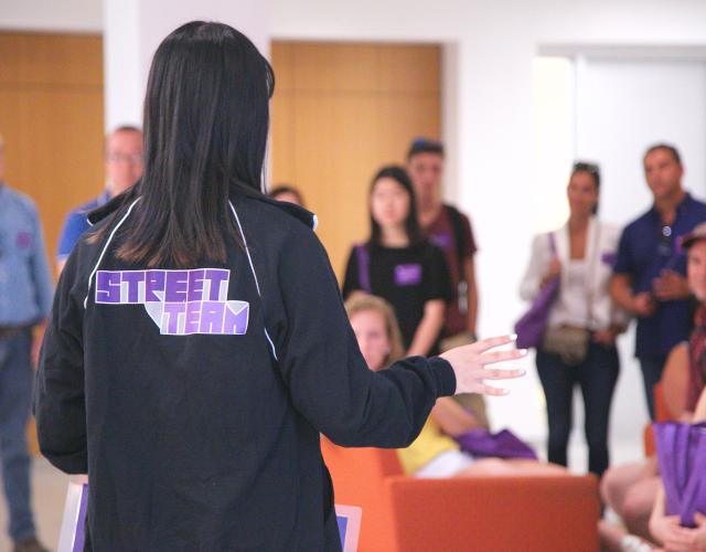 A student speaks in front of a crowd
