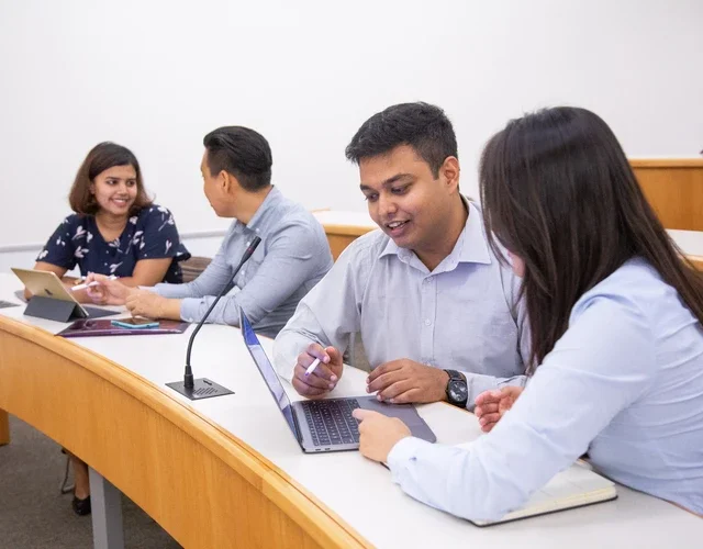 Four people collaborating in a classroom