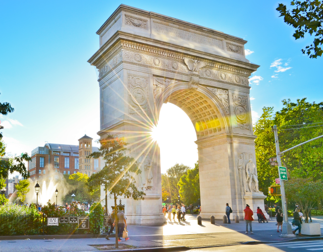 Washington Square Arch backlit by sun 
