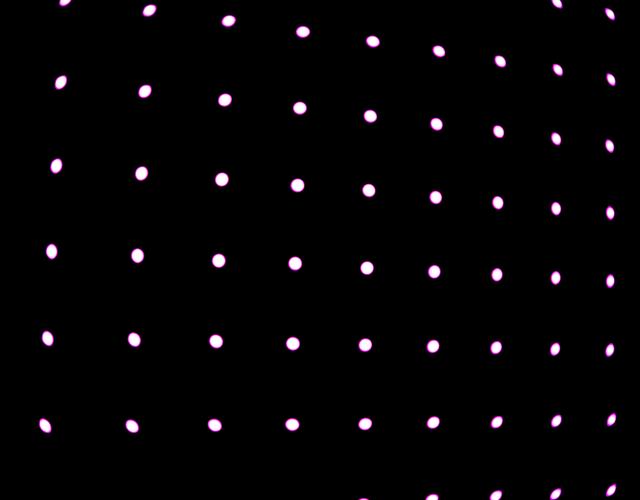Bright dots in grid formation on black background