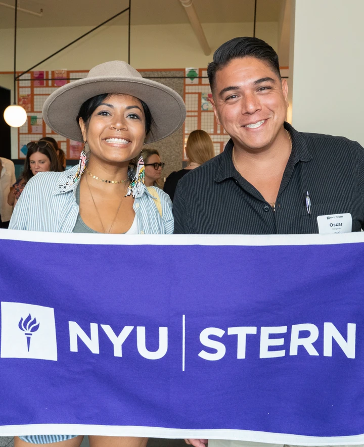 Recent alumni pose at a Stern 10 event