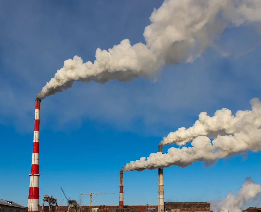 Smoke from the pipes in the factory into the atmosphere.