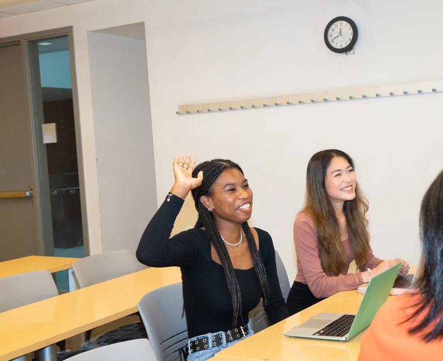 Student raising her hand in classroom