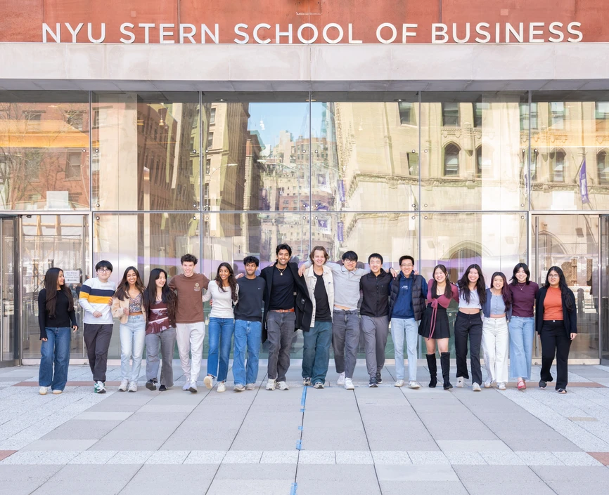 Current Stern students walking in line together outside of Tisch Hall building