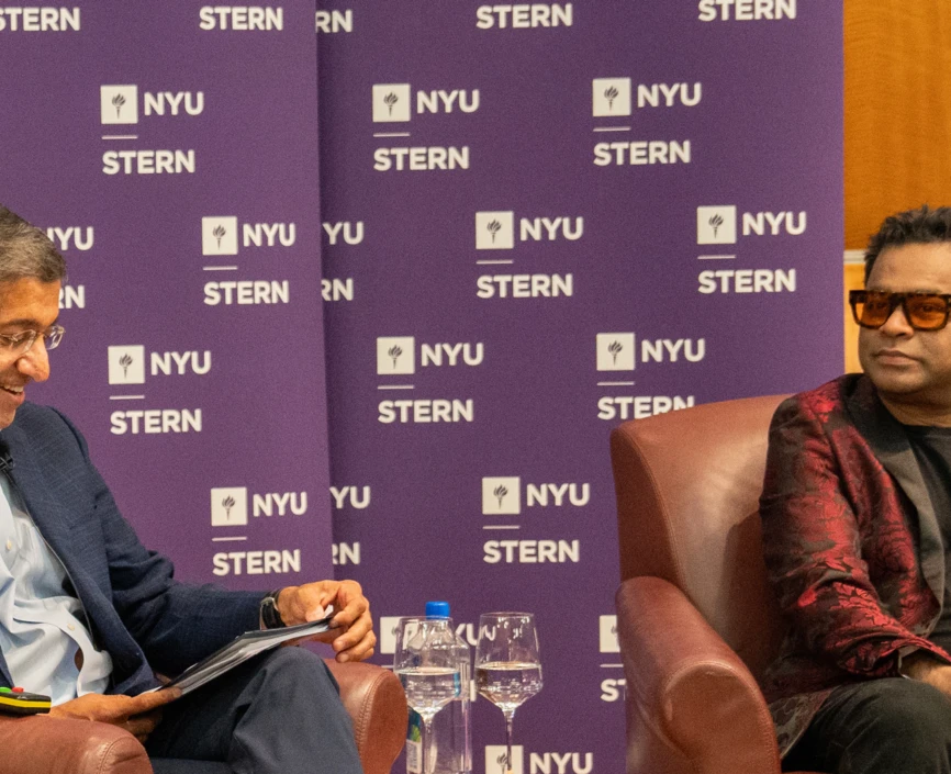 Dean Bharat and A R Rahman sitting in conversation in front of an audience