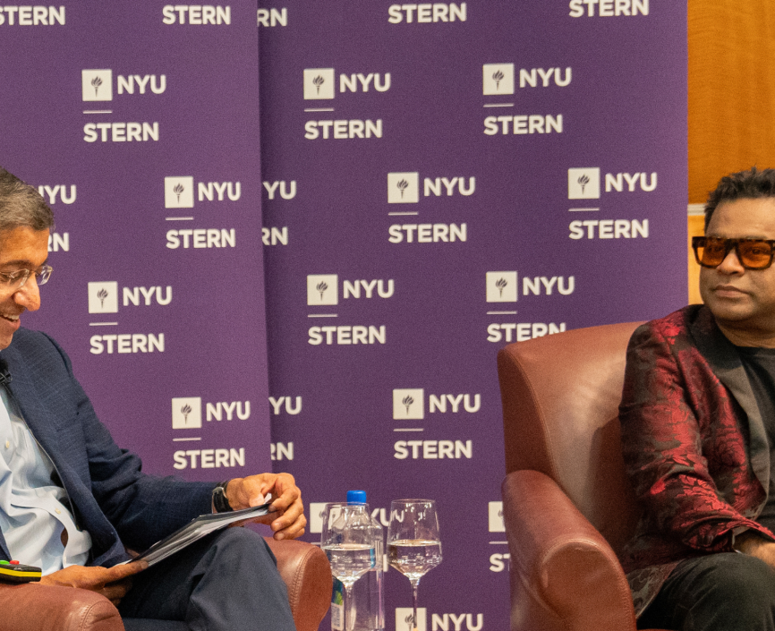 Dean Bharat and A R Rahman sitting in conversation in front of an audience