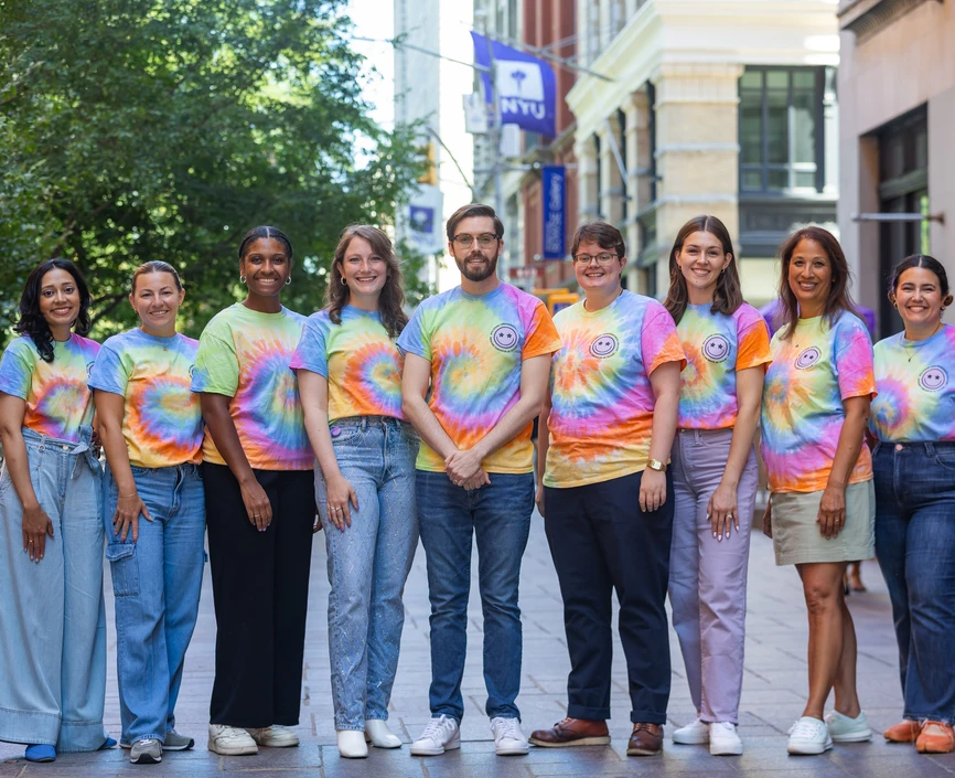 UC Advising Team stands in a line outside of Shimkin Hall