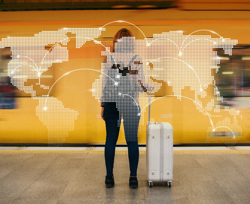 A transparent map of the world over a woman with a suitcase