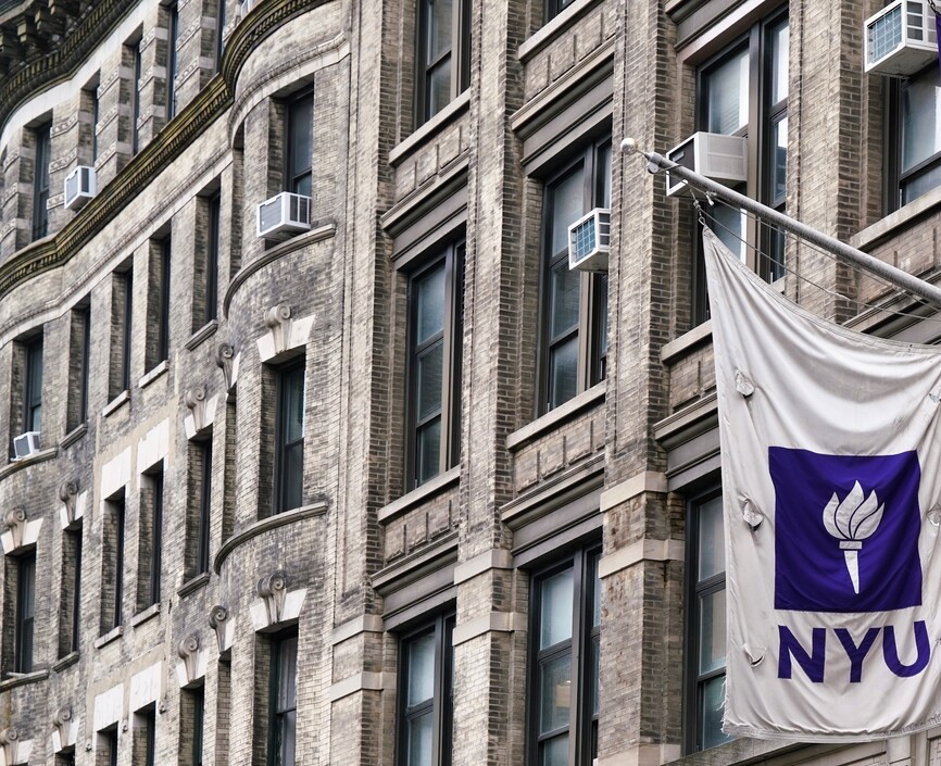 Two purple and white NYU flags 