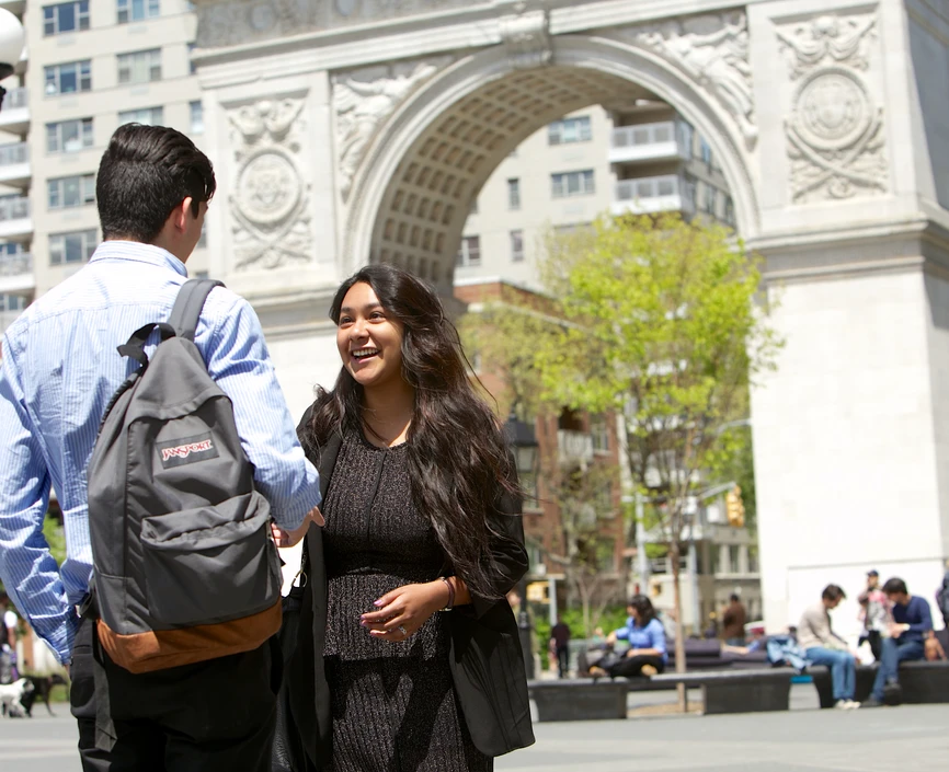 Students chat in front of the arch at Washington Square Park