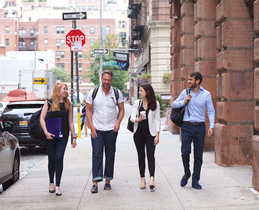 Four people walking down the street