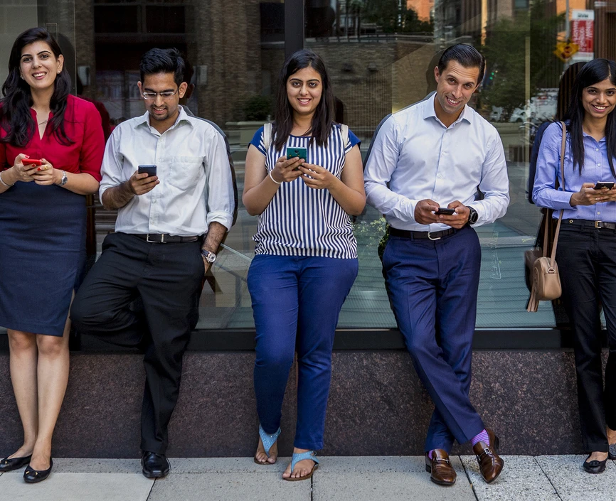 Students on their phones in Gould Plaza