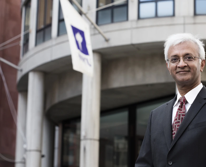 Raghu Sundaram standing in front of Kaufman Management Center