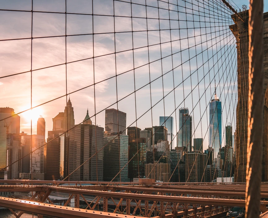Financial district skyline through the Brooklyn Bridge