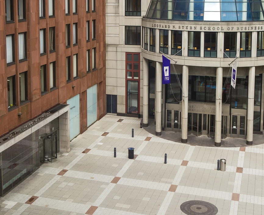 aerial view of NYU Stern's Gould Plaza, with brick Tisch building and cement rotunda in view