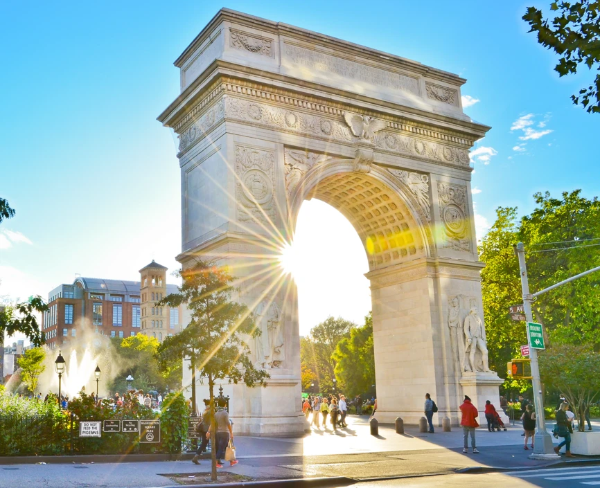 Washington Square Arch backlit by sun 