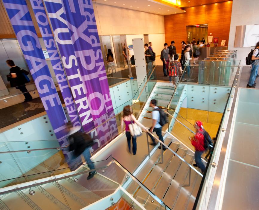 Students walking up the stairs in NYU Stern's Tisch Lobby Students walking up the stairs in NYU Stern's Tisch Lobby