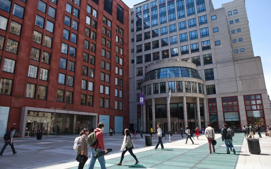 A photo of people walking in front of KMC and Tisch Hall.