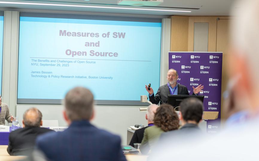 jim bessen speaking at a podium