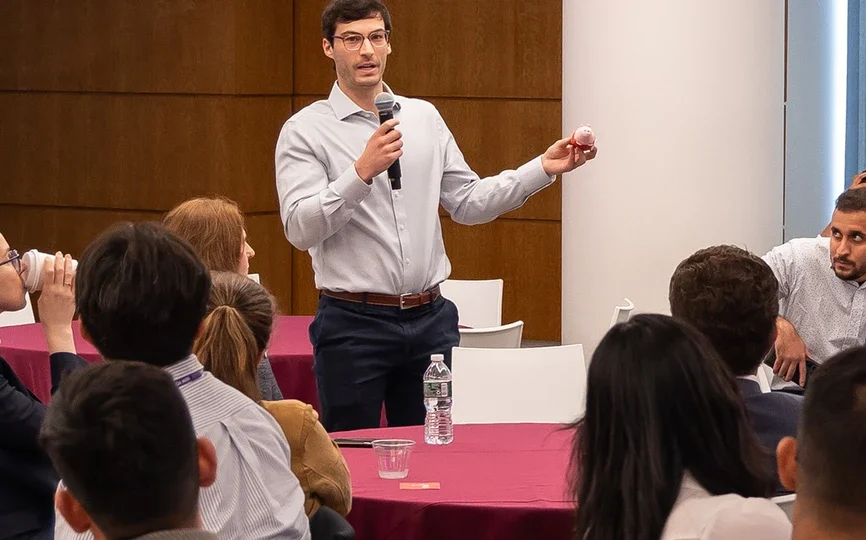 Student speaking in a conference room in front of a class.