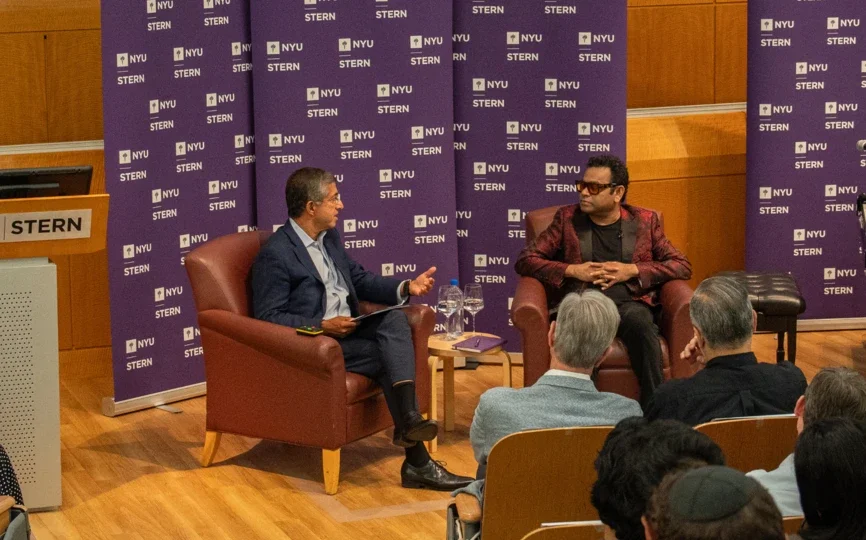 Dean Bharat and A R Rahman sitting in conversation in front of an audience
