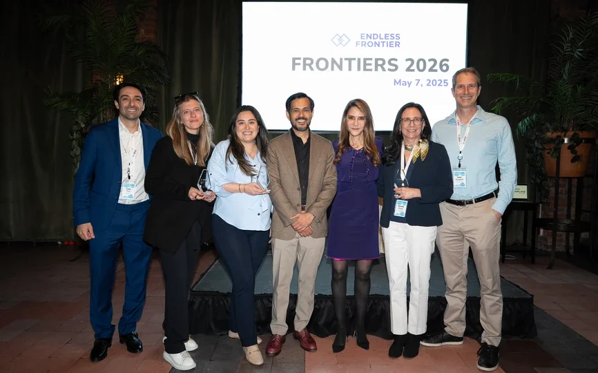 A group stands in front of a sign reading "Frontiers 2026" with the Endless Frontier Labs logo